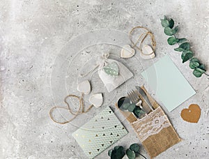 Flat lay wedding composition with card, decorations and eucalyptus, greetings, invitation