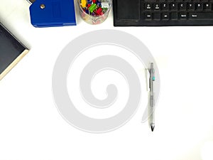 Flat lay, white desk in the office with layout space.with office equipment such as pencils, notebooks and keyboards at the top.