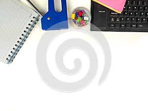 Flat lay, white desk in the office with layout space.with office equipment such as pencils, notebooks and keyboards at the top.