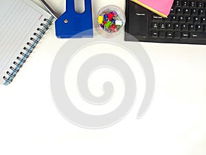 Flat lay, white desk in the office with layout space.with office equipment such as pencils, notebooks and keyboards at the top.