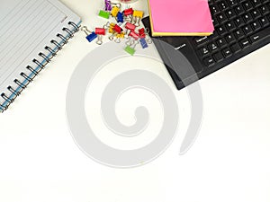 Flat lay, white desk in the office with layout space.with office equipment such as pencils, notebooks and keyboards at the top.