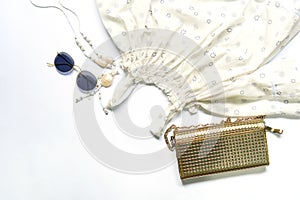 Flat lay of woman clothes and accessories set with glasses, handbag.