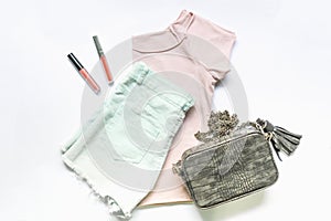 Flat lay of woman clothes and accessories set with handbag. Trendy fashion female background.