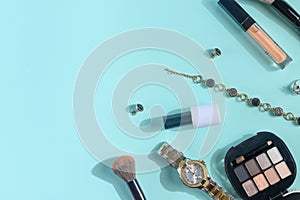 Flat lay.Women`s accessories and blogging, blue background with cosmetics, and jewelry. Women`s stores and retail sales