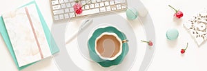 Flat lay women`s office desk banner. Female workspace with laptop, photo