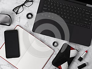 Flat lay workspace with laptop, planner, glasses, mobile phone, ear rings, hair tie, comb and lipstick