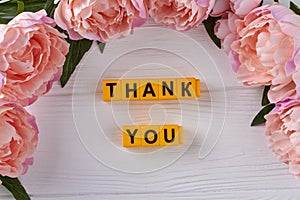 Flat lay yellow letter cubes saying thank you.