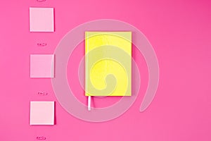 flat lay with yellow notebook with stickers and paper clips