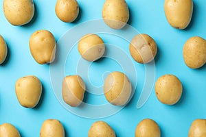 Flat lay with young potato on blue background