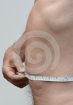 Flat Male stomach in profile with tape measure