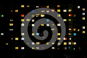 Flat night panorama of multicolor light in windows of multistory buildings. life in big city