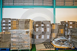 Flat pack cardboard boxes on pallet for product packaging and delivery in warehouse