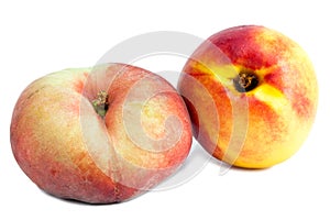 Flat peach and nectarine.Close up on a white background
