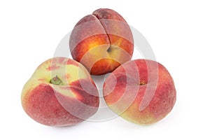Flat peaches and ordinary peach on a white background