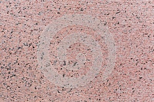 Flat pink granite block side with stone cutting tool traces