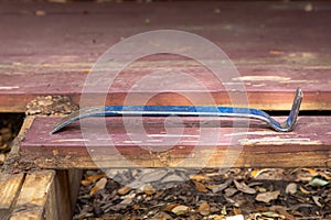 Flat pry bar on a partially demolished deck construction