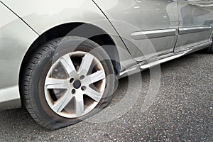 Flat rear tire on car