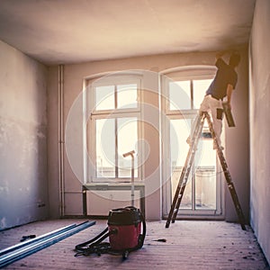 Flat renovation concept, blur image of a  person on ladder renovate room photo