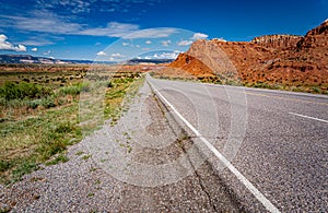 Flat road cuts through the desert area called red rocks of fire
