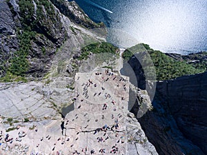 Flat rock Preikestolen over fjord Lysefjorden is natural attraction. Top view and flight up above cliff. Preacher`s Pulpit or Pre