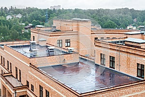 Flat roof with air conditioners top modern apartment house building mixed-use urban multi-family residential district area