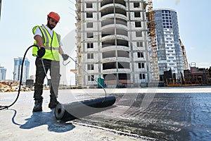 Flat roof construction and insulation. Heating and melting bitumen roofing felt