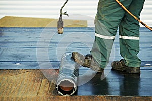 Flat roof covering repair works with roofing felt