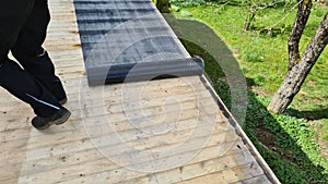 Flat roof repair: roofer welds roof waterproofing. Roof renovation with gas burner
