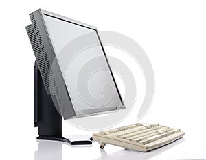 Flat screen LCD monitor with old classic keyboard on white background