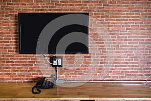 Flat screen television on a brick wall