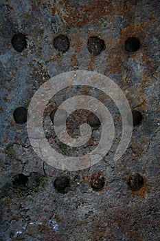 Flat sheet of rusty iron cast iron with horizontal rows of round holes. Highly Detailed Grunge Metal Background Texture.