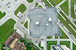 Flat shingle roof of high-rise apartment building with ventilation systems. aerial photo