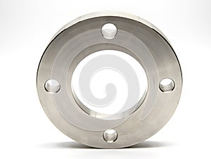 Flat stainless steel flange on a light background