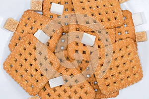 Flat sugar cookies and sugar cubes, top view close-up