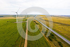 Flat terrain with lots of wind turbines in the fields and a highway stretching into the distance. The view from the top. photo