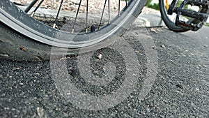 The flat tire of a bicycle closeup photo