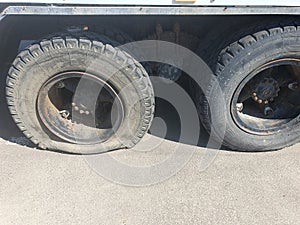 Flat tire of a heavy duty truck on the road