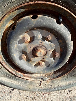 Flat tire and rusty car, old car elements