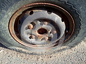 Flat tire and rusty car, old car elements