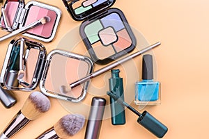 Flat view of cosmetics - lipstic, face-powder, brushes, nail polish.