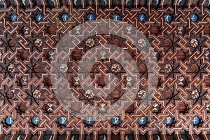 Flat view of decorated wooden ceiling of cloister\'s corridor of a Monastery