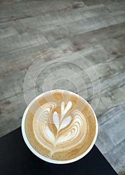 Flat white coffee in a cafe latte art on wooden floor photo