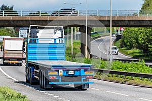 Flatbed lorry truck on uk motorway in fast motion