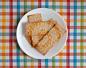 Flatbread salted multigrain crackers on a white plate