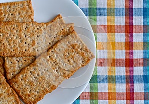Flatbread salted multigrain crackers on a white plate