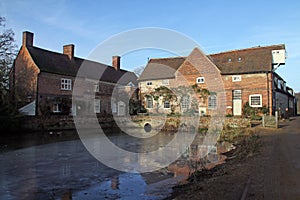 Flatford Mill buildings reflected in the mill pond