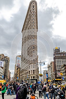 Flatiron Building New York City with lots of People standing in the forefront