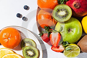 Flatlay assorted fresh and ripe fruits and berries on a plate. The concept of healthy eating.