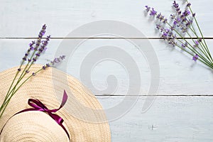 Flatlay composition with summer fashion accessories, straw hat, clothes, tea cup, blank paper card mockup, daisy flowers on pastel