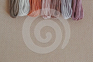 flatlay creativity: canva aida beige and multi-colored thread mouline thread,